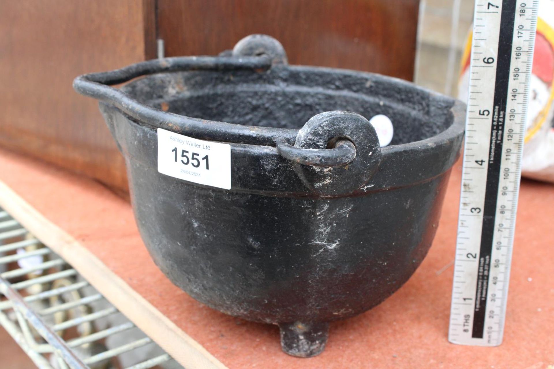 A SMALL CAST IRON HANGING CAULDRON