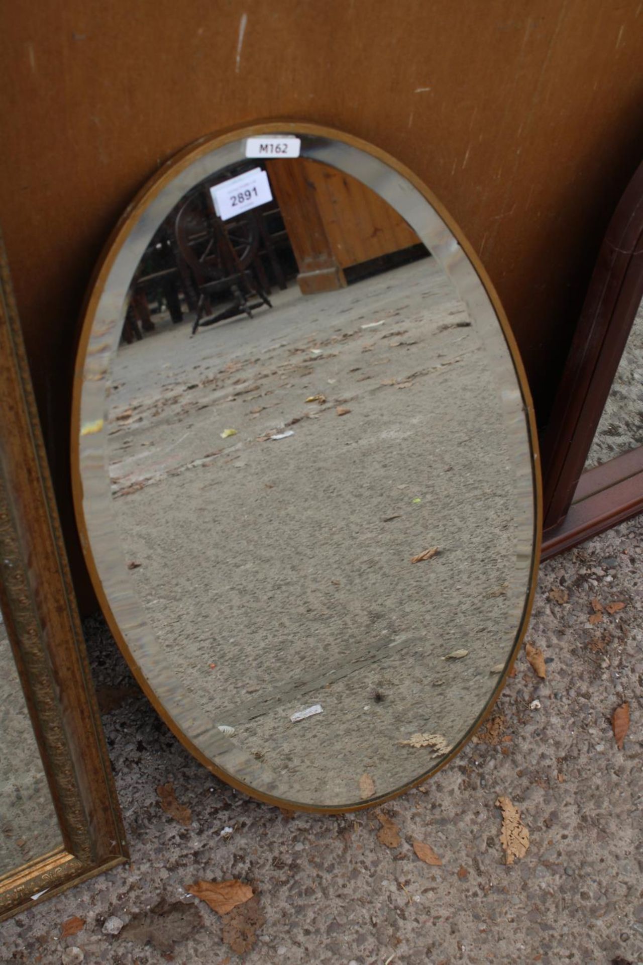 A MODERN OVAL METAL FRAMED BEVEL EDGE WALL MIRROR, 27" X 15" - Image 2 of 2