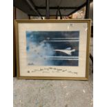 A FRAMED PRINT OF CONCORDE FLYING WITH THE RED ARROWS, SIGNED, 54CM X 44CM