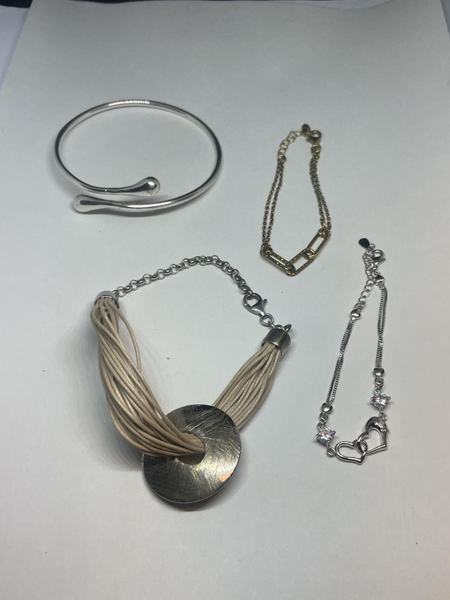 THREE SILVER BRACELETS AND A SILVER BANGLE