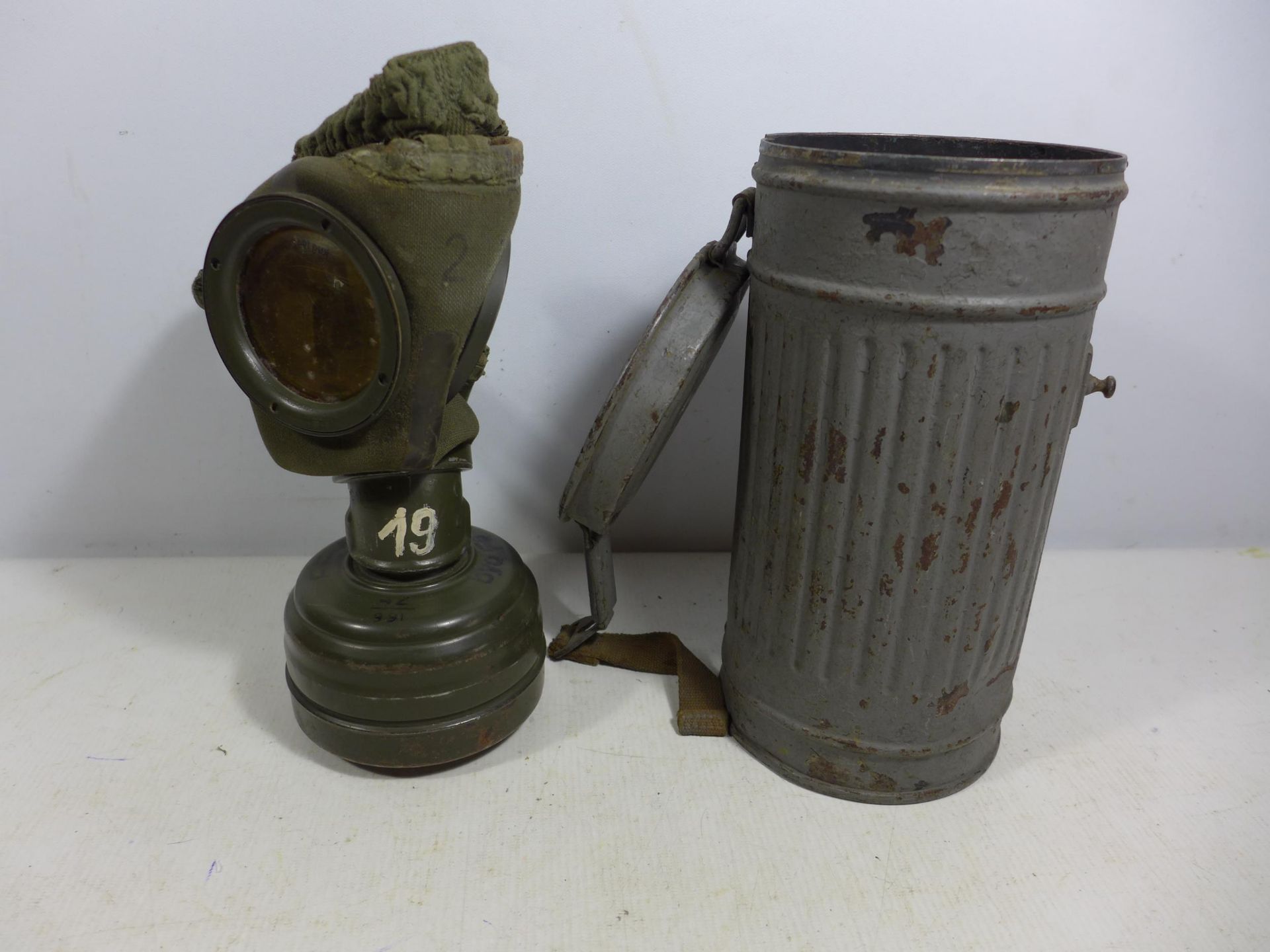 A MID 20TH CENTURY GERMAN GAS MASK AND METAL CONTAINER