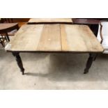 A LATE VICTORIAN SCRUB TOP WIND-OUT DINING TABLE WITH CANTED CORNERS ON TURNED AND FLUTED LEGS