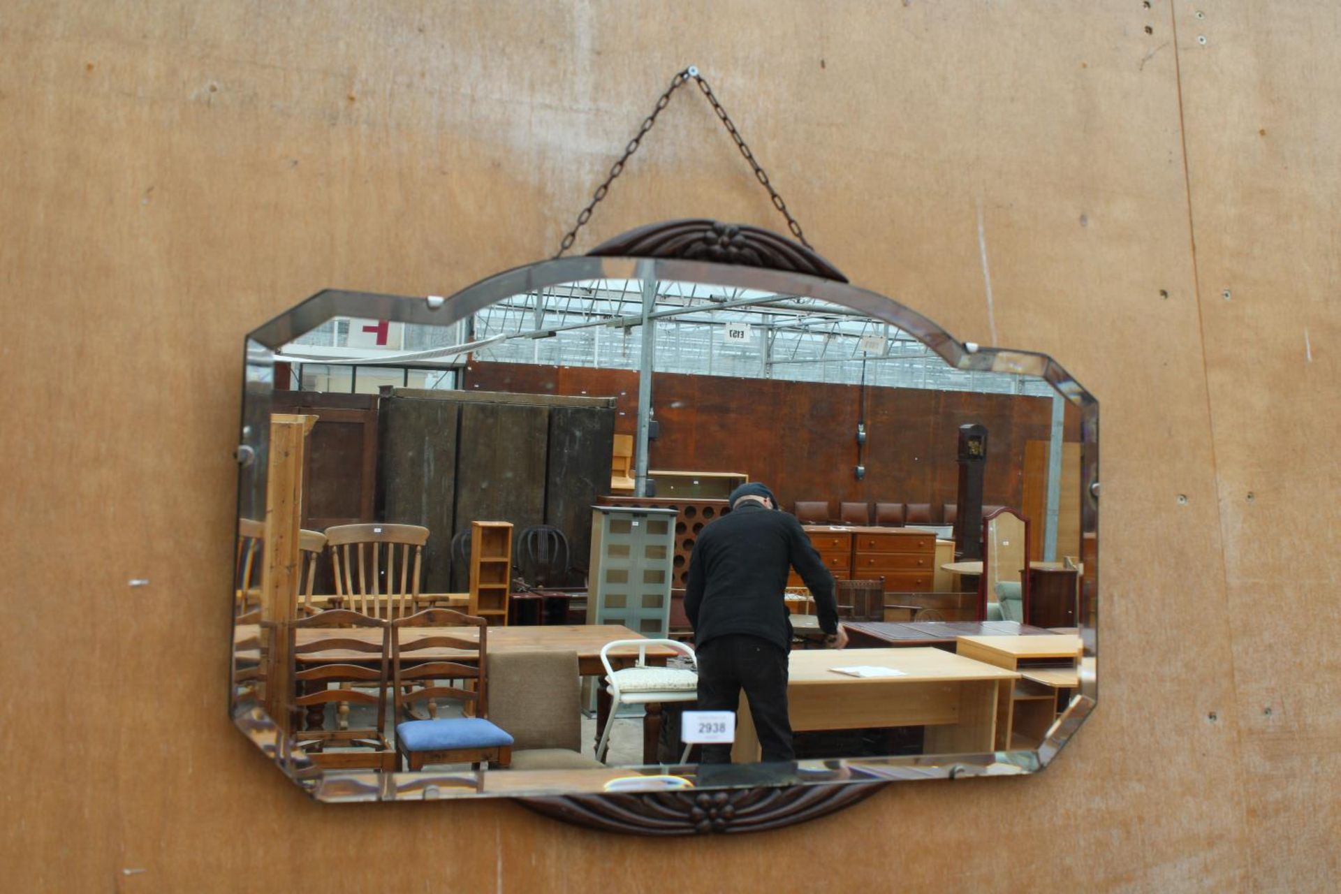 A MID CENTURY FRAMELESS WALL MIRROR WITH OAK FOLIATE DECORATION