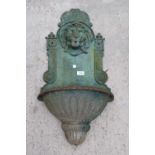 A WALL MOUNTED CAST IRON WATER FEATURE