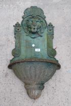 A WALL MOUNTED CAST IRON WATER FEATURE