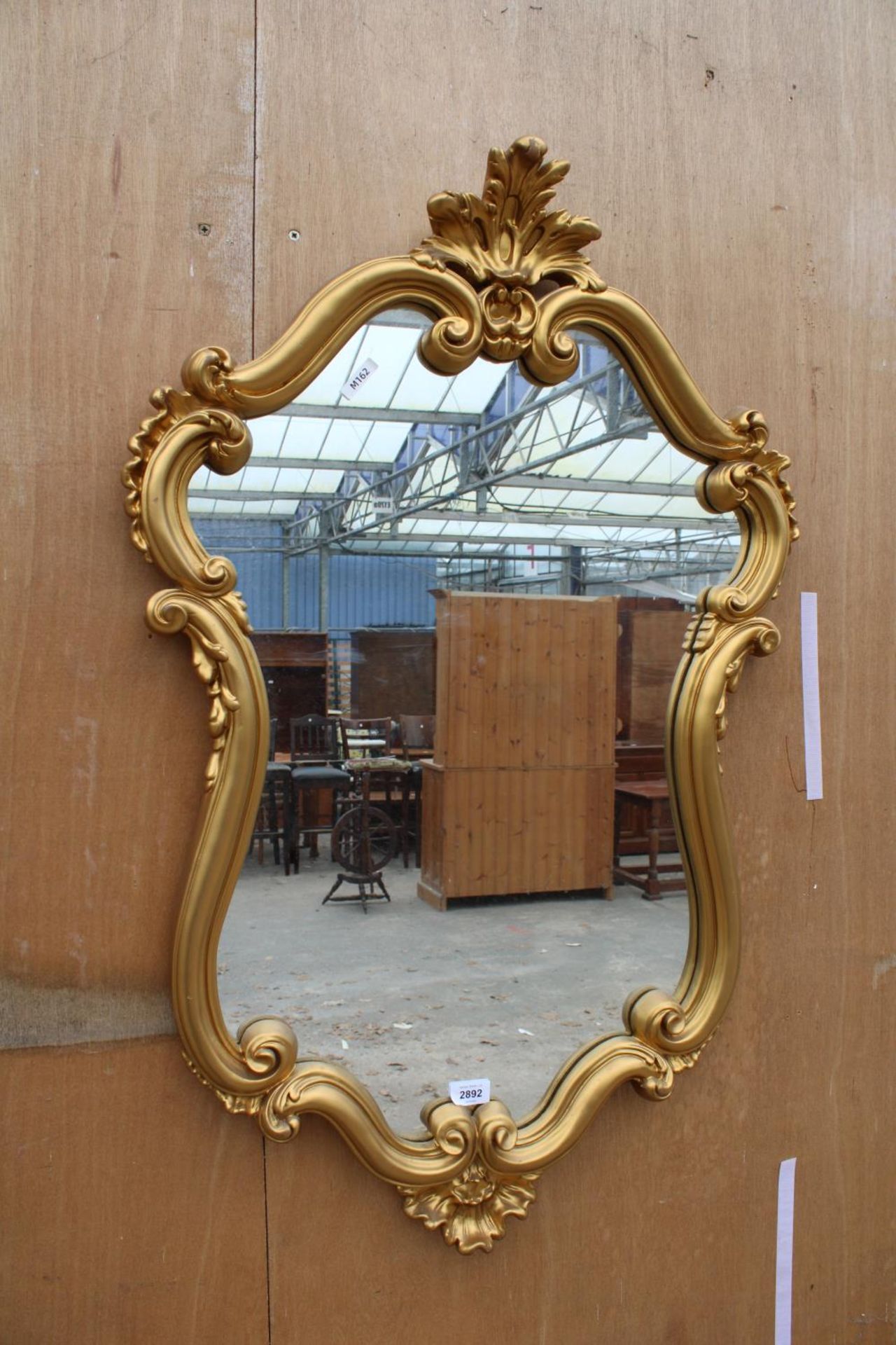 A 19TH CENTURY STYLE GOLD COLOURED WALL MIRROR, 39" X 25"