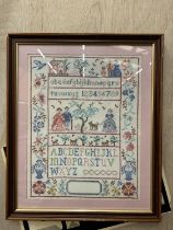 A FRAMED HAND EMBROIDERED SAMPLER