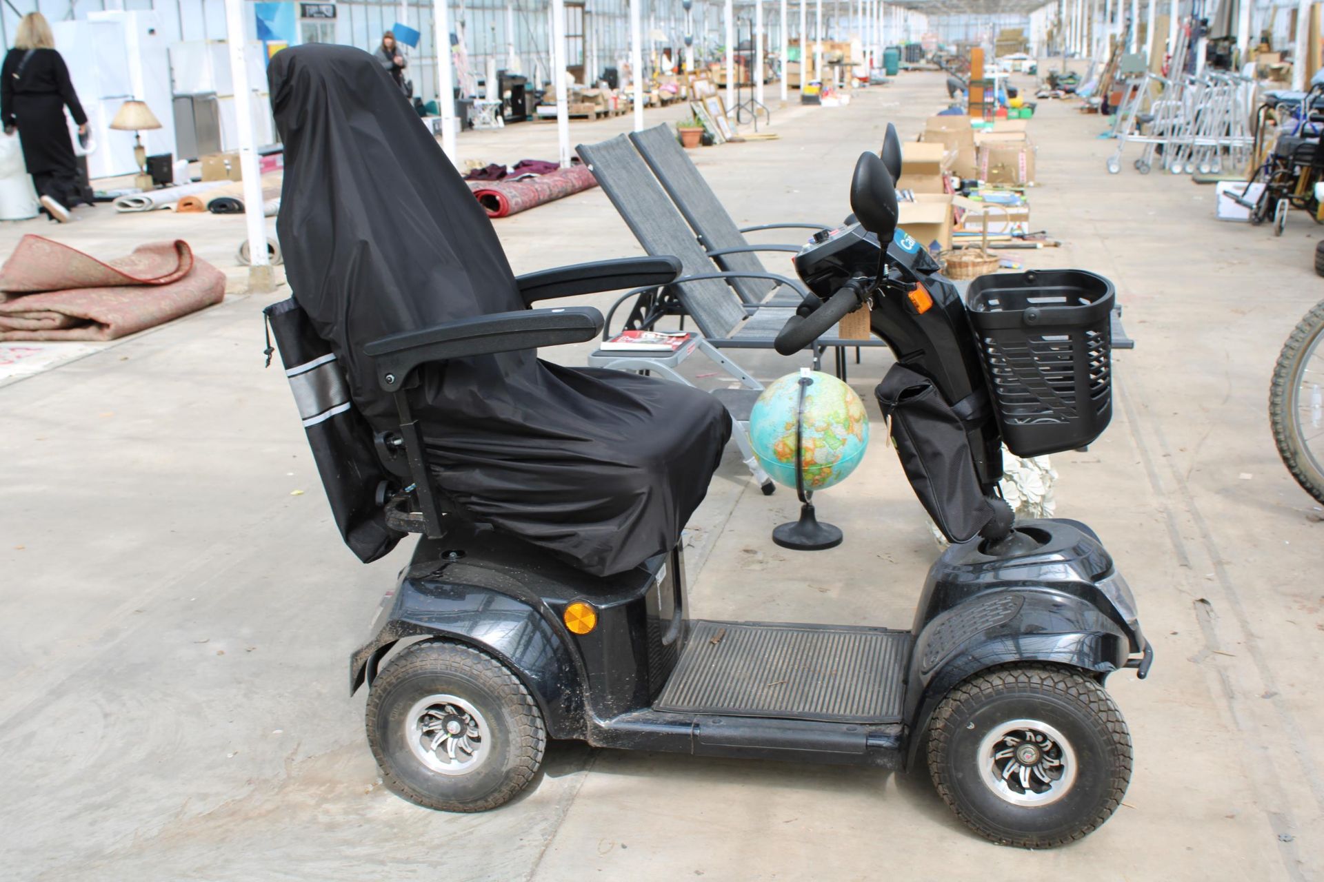 A FOUR WHEEL CARE CO ELECTRIC MOBILITY SCOOTER COMPLETE WITH CHARGER