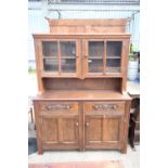 AN OAK AND BEECH E.GOMME FURNITURE DRESSER WITH GLAZED UPPER PORTION 55" WIDE
