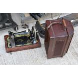 A VINTAGE SINGER SEWING MACHINE WITH WOODEN CARRY CASE