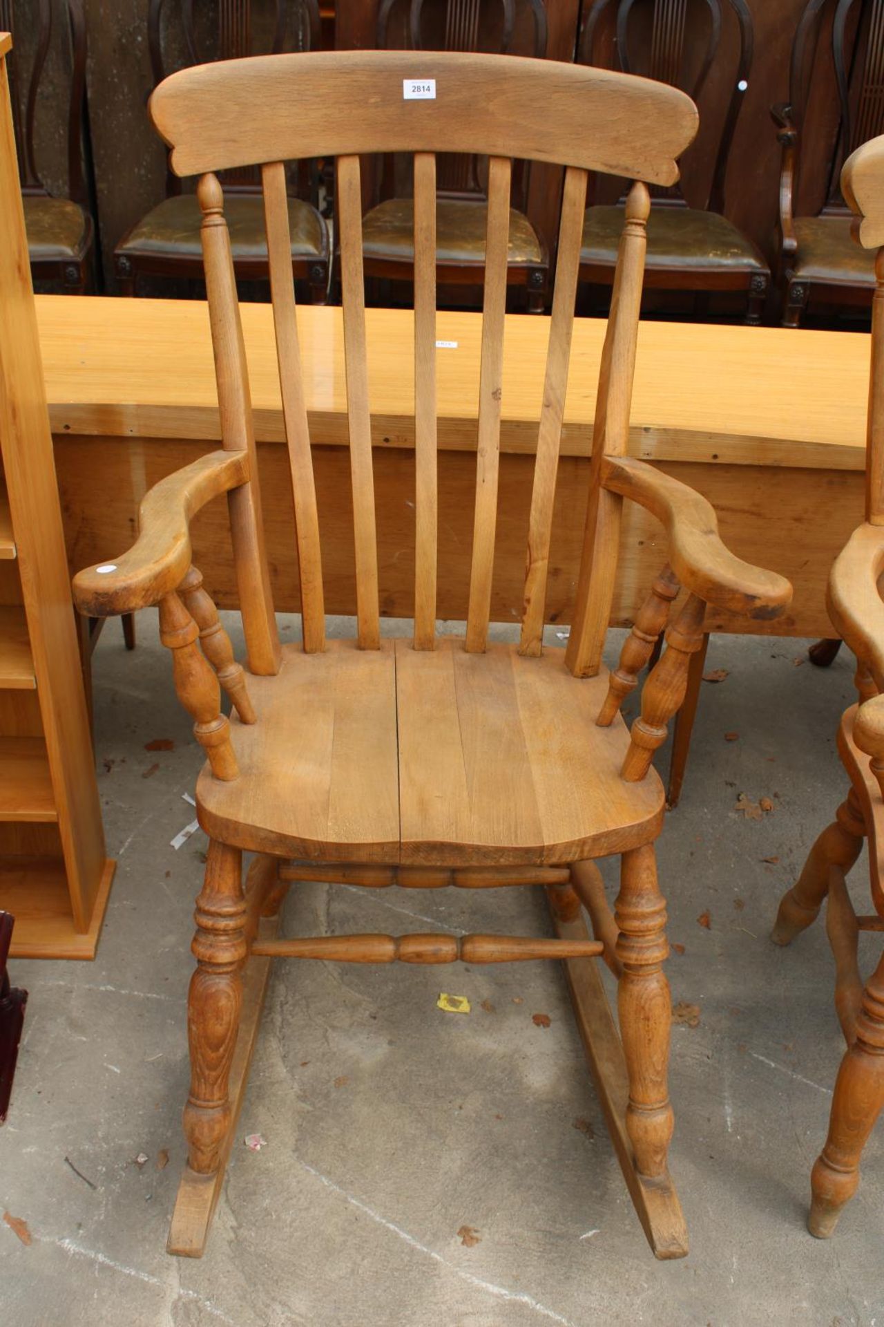 A VICTORIAN STYLE BEECH ROCKING CHAIR