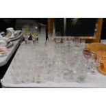 A LARGE QUANTITY OF GLASSES TO INCLUDE CHAMPAGNE FLUTES, WINE, SHERRY, TUMBLERS, DESSERT BOWLS, ETC