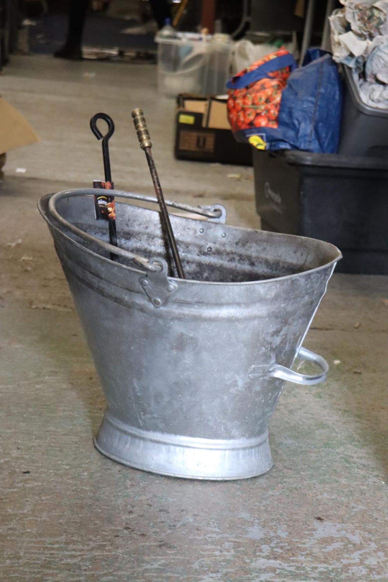 A LARGE TIN COAL SCUTTLE WITH TWO POKERS