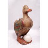 A LARGE SOLID WOODEN GOOSE AND EGG FIGURE, HEIGHT APPROX 46CM