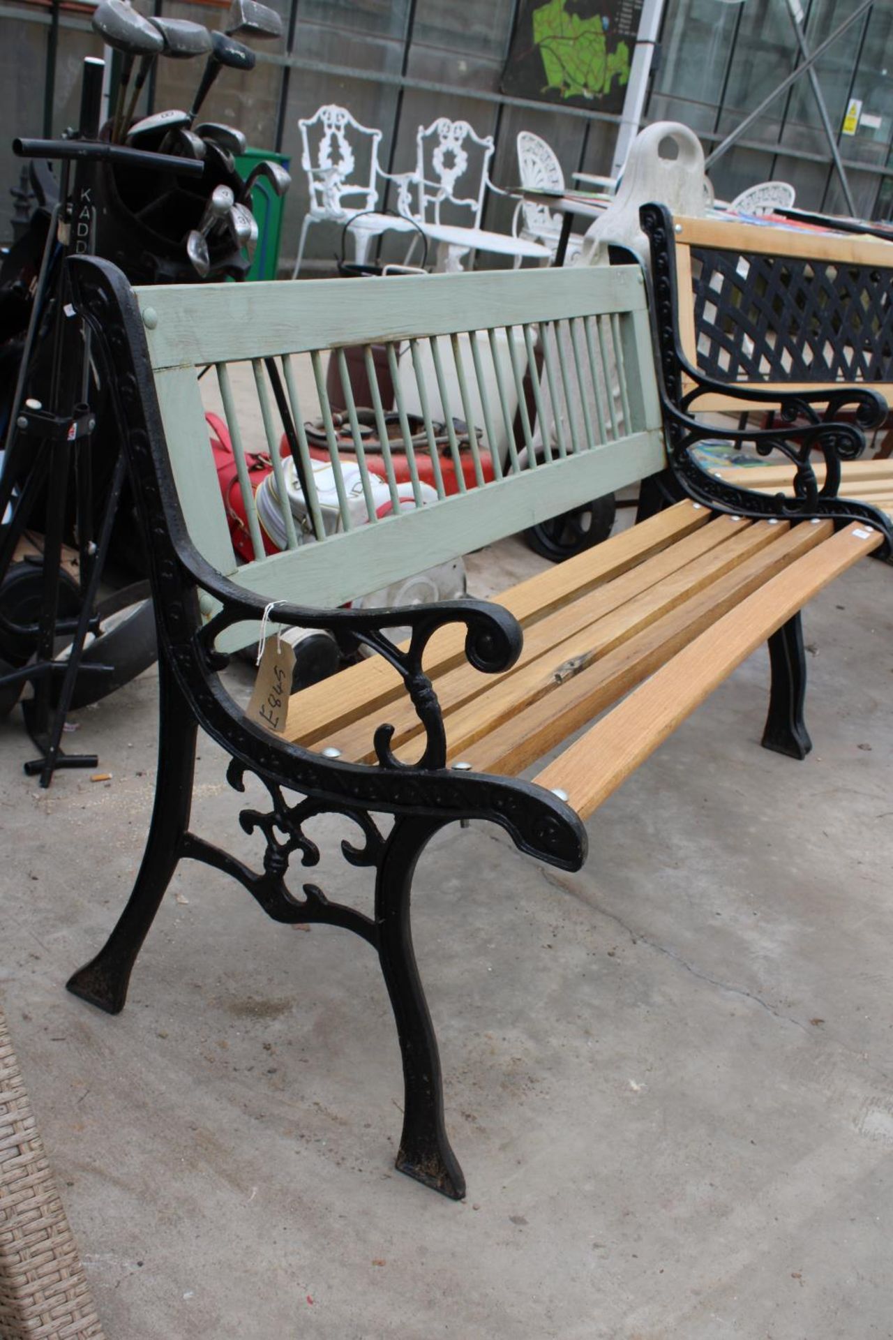 A WOODEN SLATTED GARDEN BENCH WITH DECORATIVE CAST BENCH ENDS - Image 2 of 2