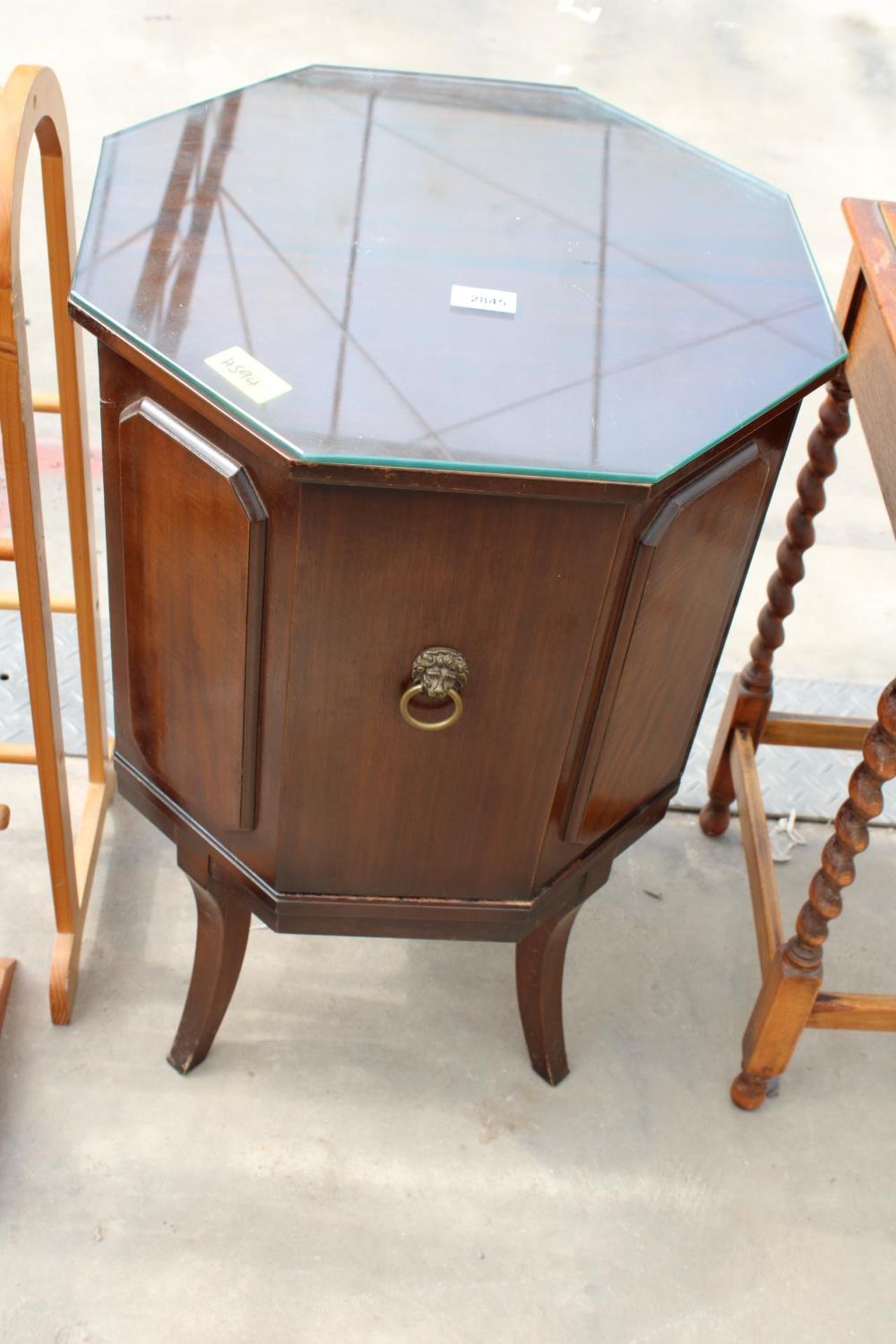 A MODERN OCCASIONAL DRINKS CABINET ON LEGS