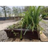 ONE BROWN SALT GLAZED PIG TROUGH WITH PLANTS MEASURING 76CM IN LENGTH BY 29CM WIDTH APPROX 23CM IN