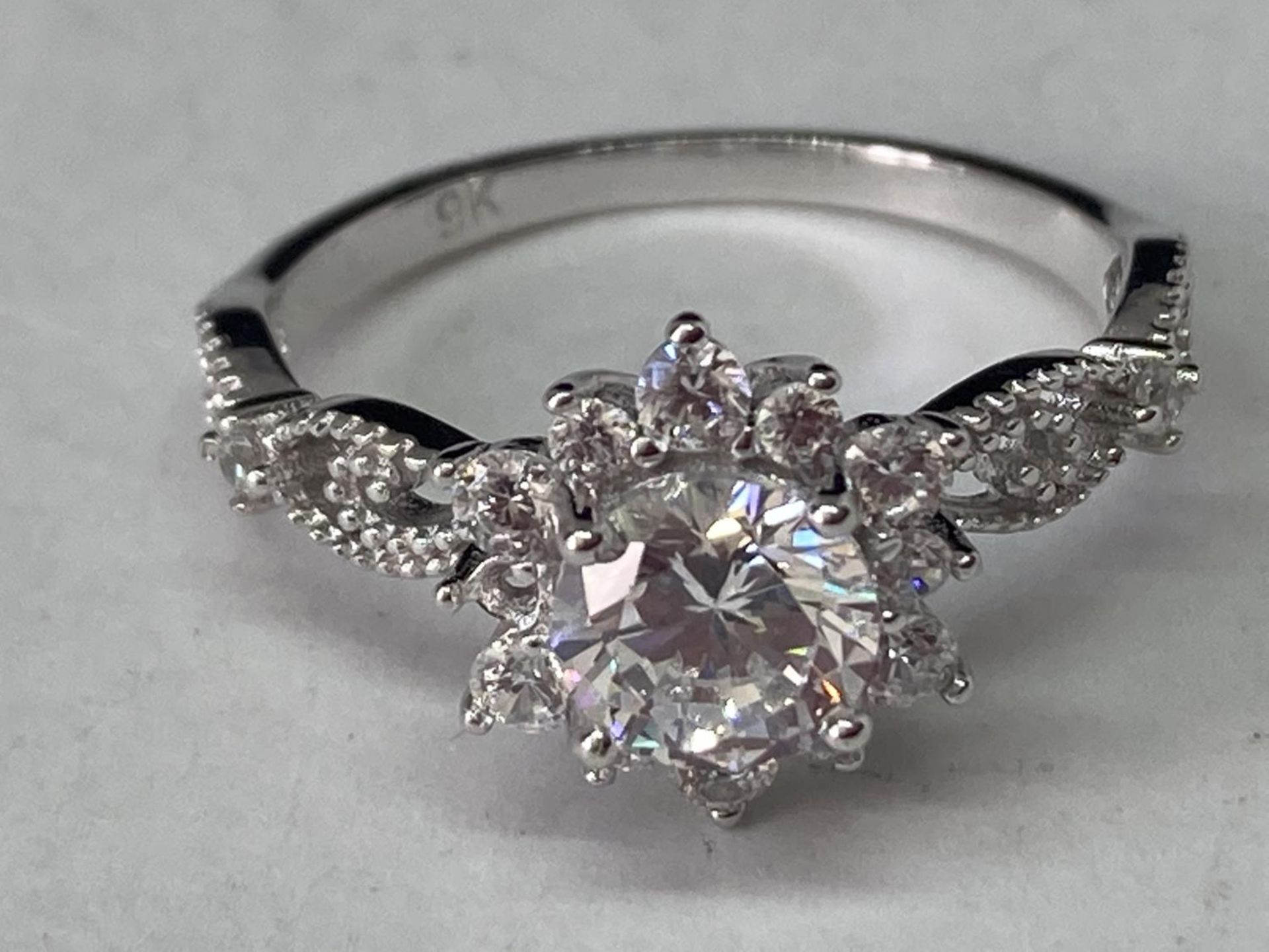 A WHITE METAL RING WITH ONE CARAT OF MOISSANITE IN A CLUSTER DESIGN AND ON THE DECORATIVE - Bild 2 aus 8