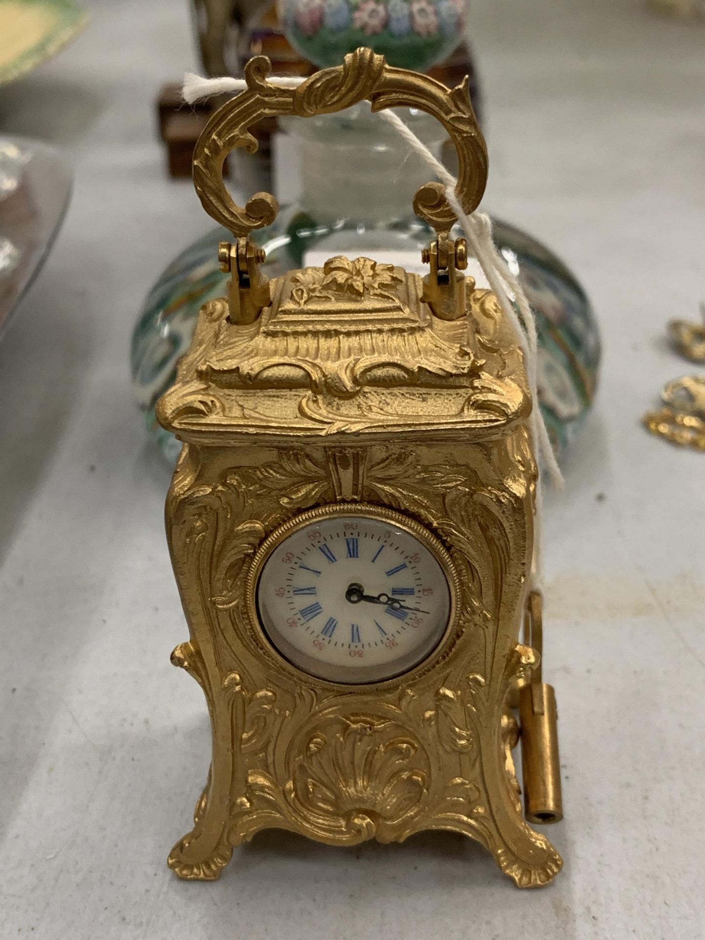 A MINIATURE GILDED FRENCH CLOCK WITH KEY HEIGHT 3.5" SEEN WORKING BUT NO WARRANTY