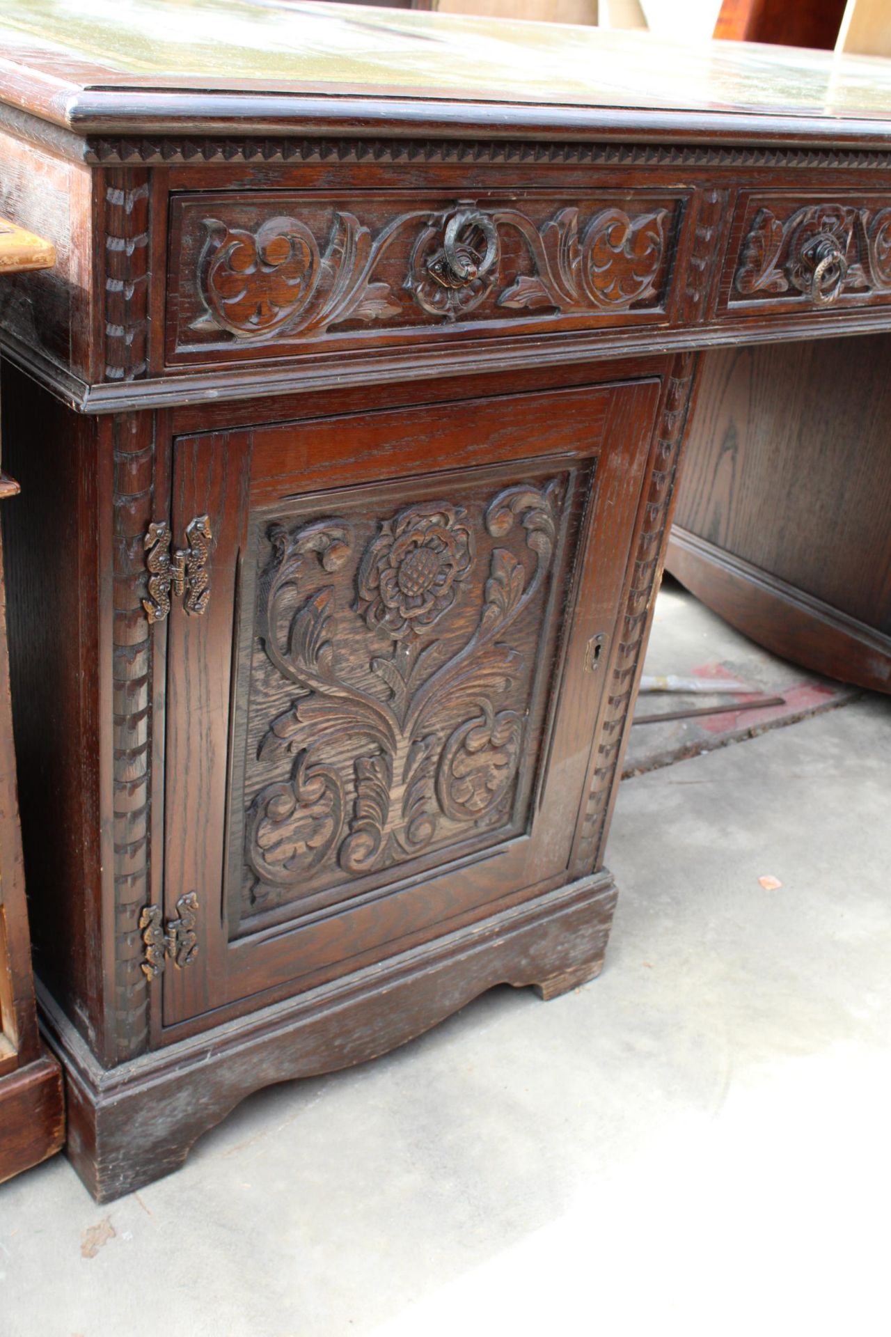 AN OAK JAYCEE TWIN-PEDESTAL DESK, TWO CARVED CUPBOARDS AND THREE DRAWERS WITH INSET LEATHER TOP, 68" - Image 3 of 3