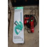 A CHAMPION ELECTRIC CHAINSAW AND AN ELECTRIC HEDGE TRIMMER