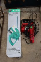 A CHAMPION ELECTRIC CHAINSAW AND AN ELECTRIC HEDGE TRIMMER