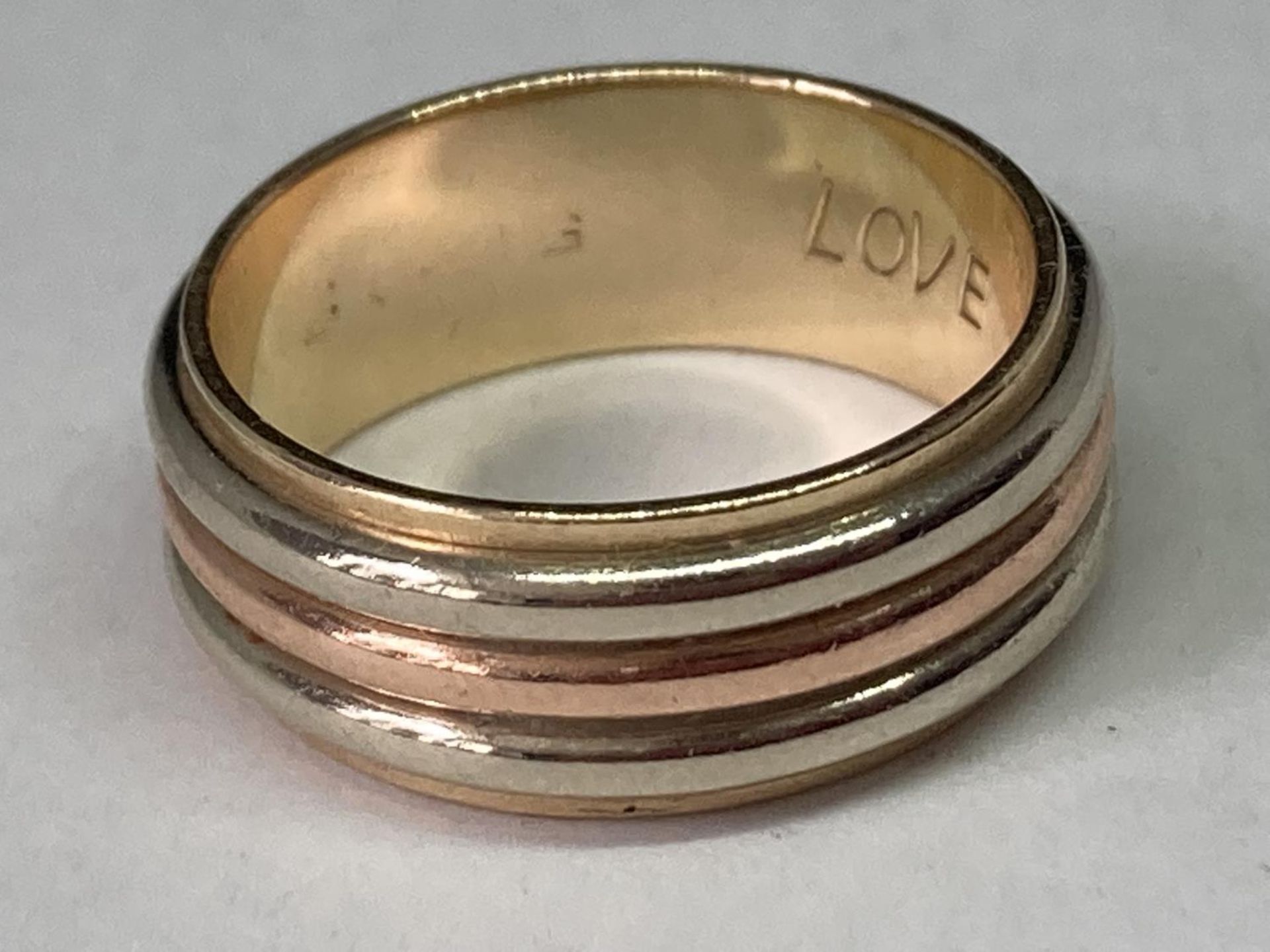 A TESTED TO 9 CARAT THREE COLOUR GOLD RING ENGRAVED INSIDE GROSS WEIGHT 7.99 GRAMS