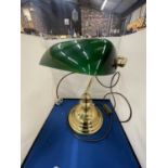 A BRASS BANKERS LAMP WITH A GREEN GLASS SHADE