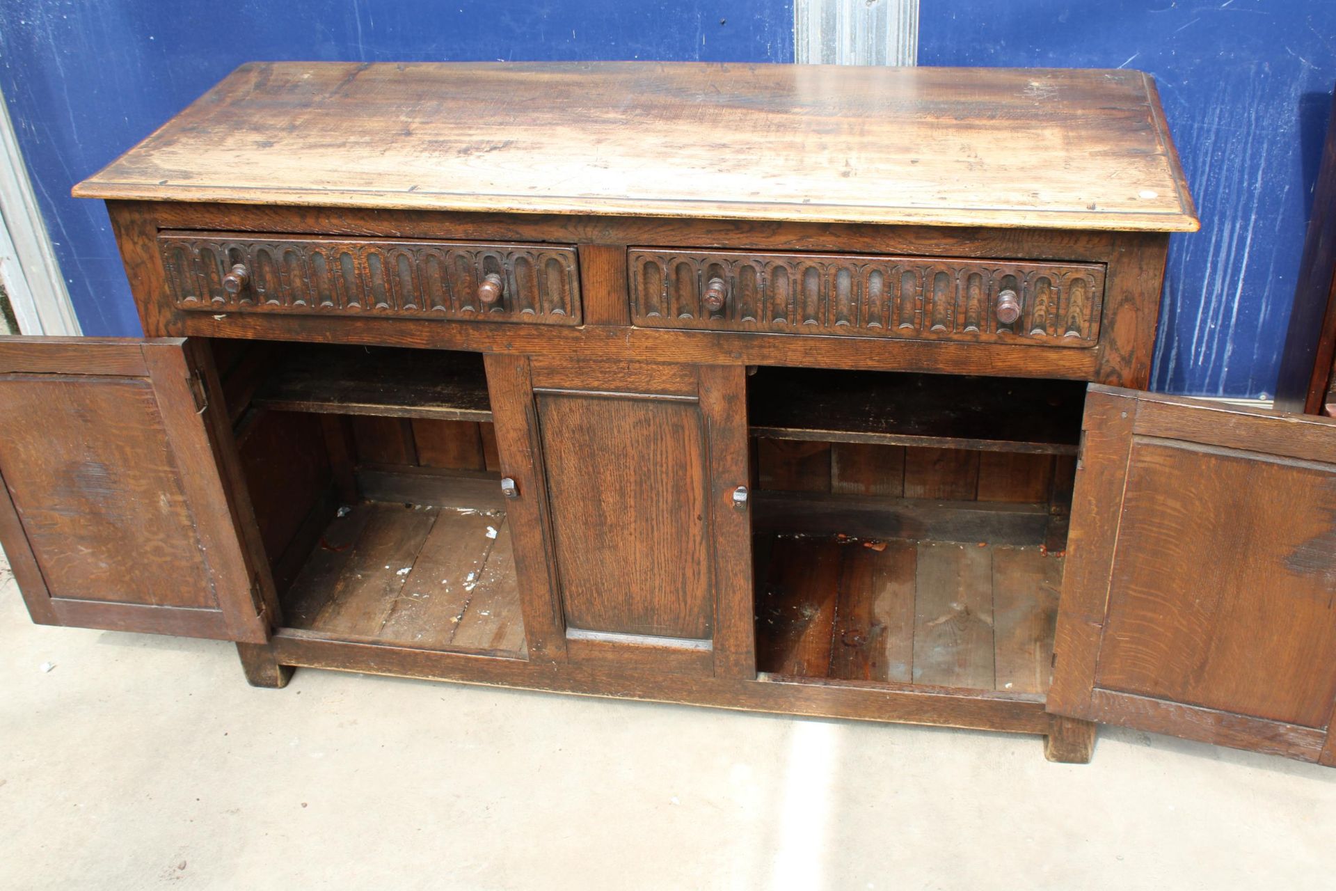 AN OAK JACOBEAN STYLE DRESSER BASE WITH CARVED PANEL DOORS AND DRAWERS, 51" WIDE - Image 3 of 3