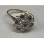 A 9 CARAT GOLD RING WITH SAPPHIRE AND CUBIC ZIRCONIAS IN A CLUSTER DESIGN SIZE M/N
