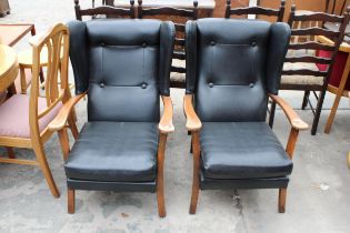 A PAIR OF MID 20TH CENTURY WINGED FIRESIDE CHAIRS