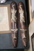A PAIR OF INDONESIAN HANDCARVED LONG FACED MASKS, LENGTH I METRE