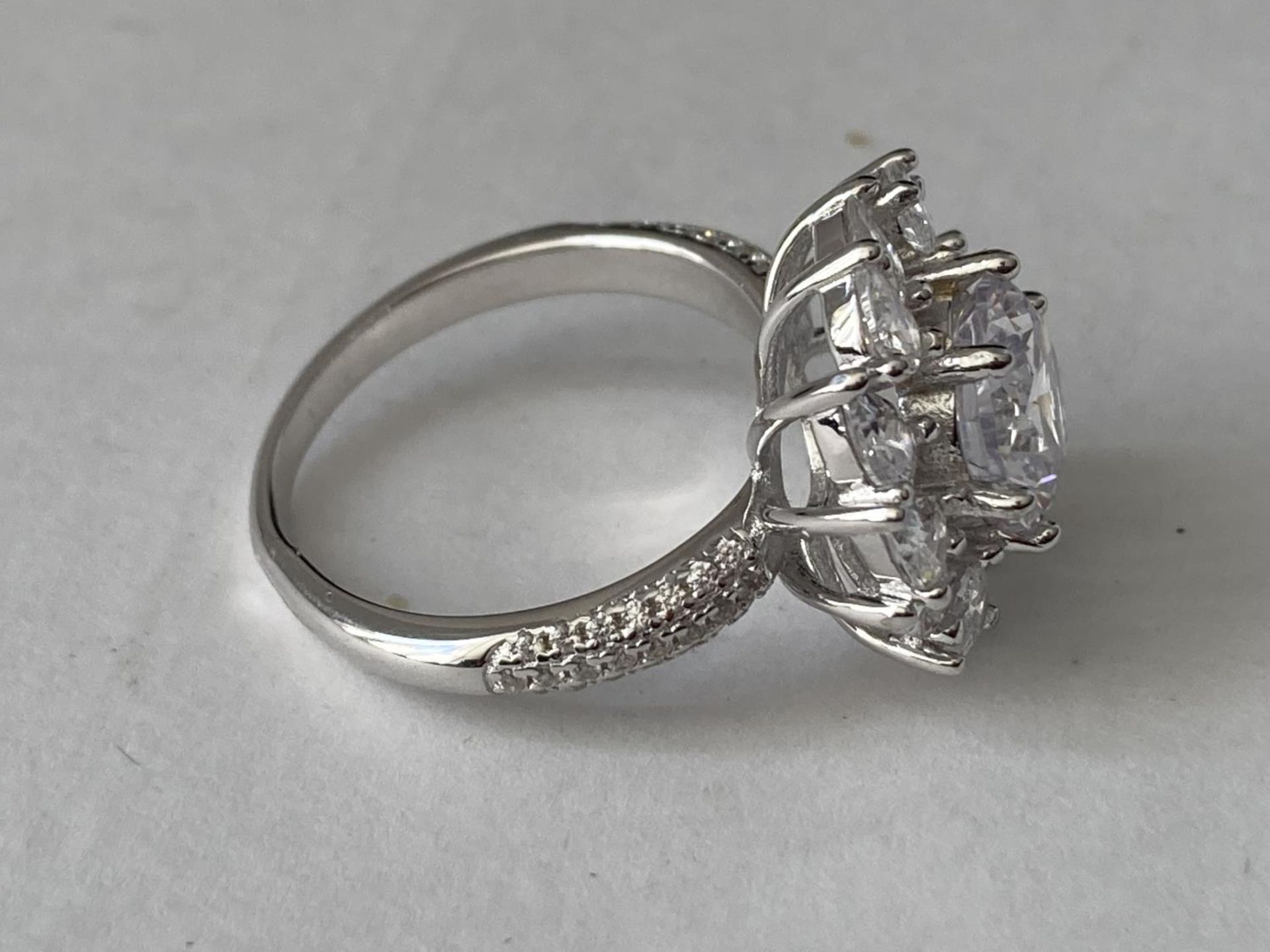 A WHITE METAL RING WITH 3 CARATS OF MOISSANITE IN A FLOWER DESIGN AND ON THE SHOULDERS SIZE P/Q - Image 7 of 8