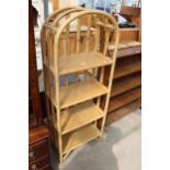 A MODERN ARCHED TOP BAMBOO AND WICKER FOUR TIER OPEN UNIT, 22" WIDE