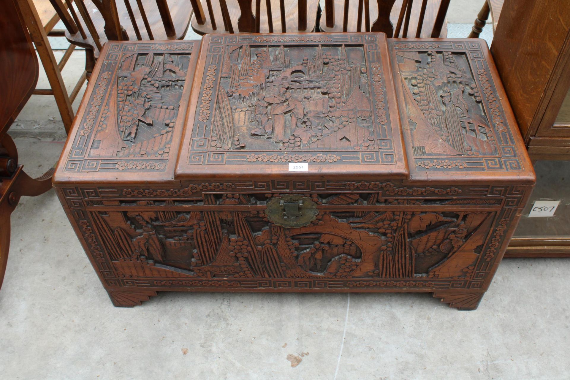 A HEAVILY CARVED CAMPHOR WOOD BLANKET CHEST, 40" WIDE