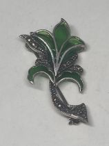 A SILVER, MARCASITE AND GREEN GLASS FLOWER BROOCH