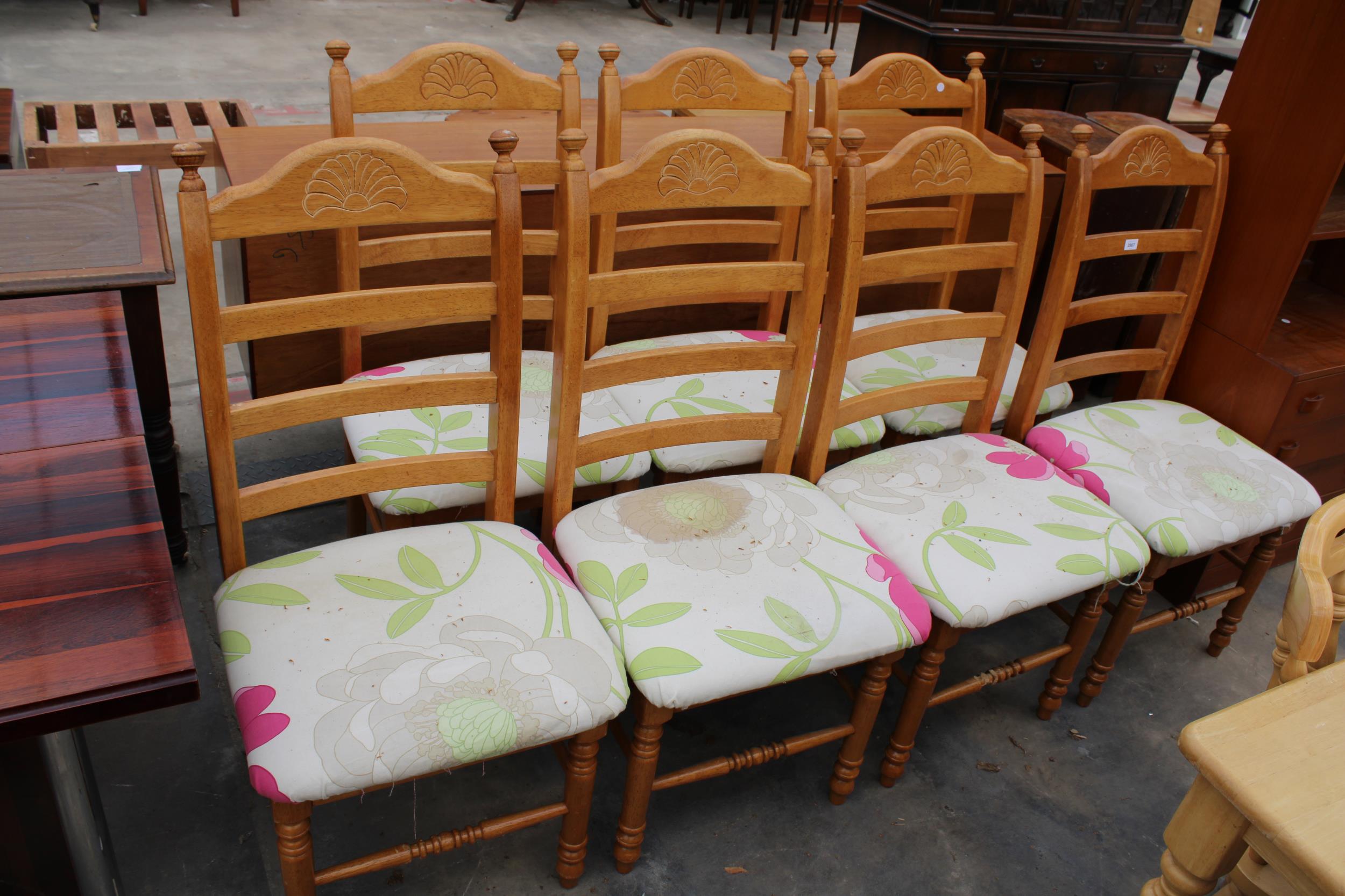 A SET OF SEVEN MODERN HARDWOOD LADDER-BACK DINING CHAIRS