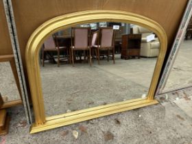 AN ORNATE GILT FRAMED OVAL MIRROR