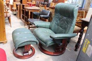 A STRESSLESS EKORNES RECLINING SWIVEL CHAIR AND STOOL