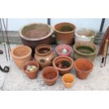 AN ASSORTMENT OF PLANT POTS TO INCLUDE TERRACOTTA EXAMPLES AND A STRAWBERRY POT ETC