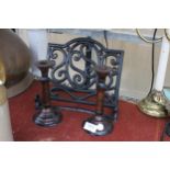 A CAST IRON BOOK STAND AND A PAIR OF VINTAGE WOODEN CANDLESTICKS