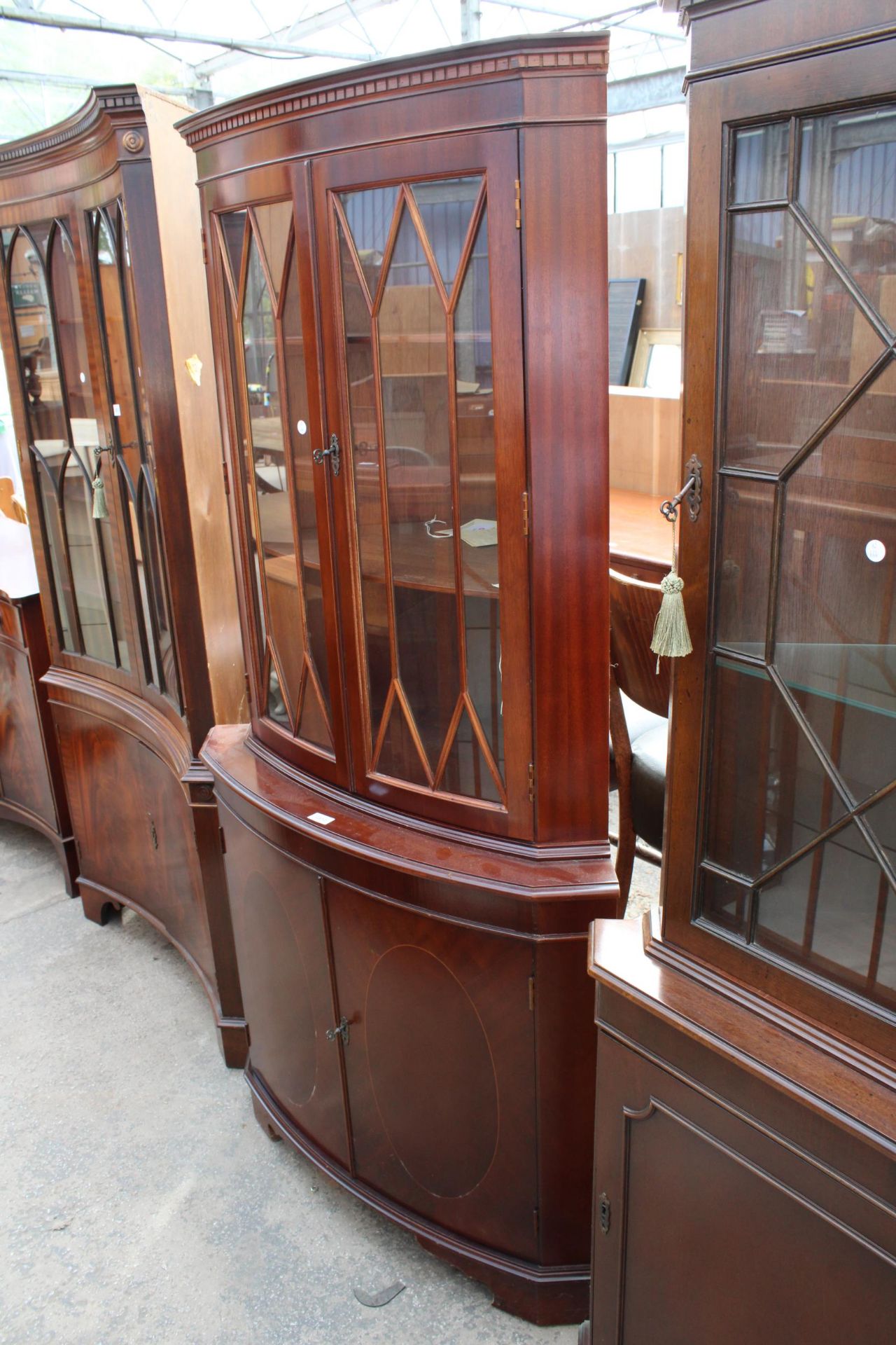 A MODERN MAHOGANY BOW FRONTED CORNER CUPBOARD WITH ORIGINAL RECEIPT £440 (2003)