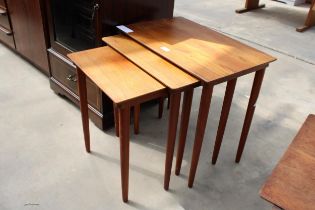 A RETRO TEAK NEST OF THREE TABLES ON TAPERING LEGS