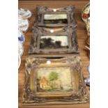 THREE VINTAGE OVER PAINTED PRINTS OF COUNTRYSIDE SCENES, IN ORNATE GILT FRAMES
