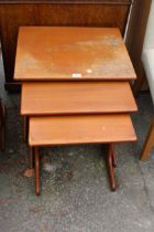 A RETRO TEAK NEST OF THREE TABLES