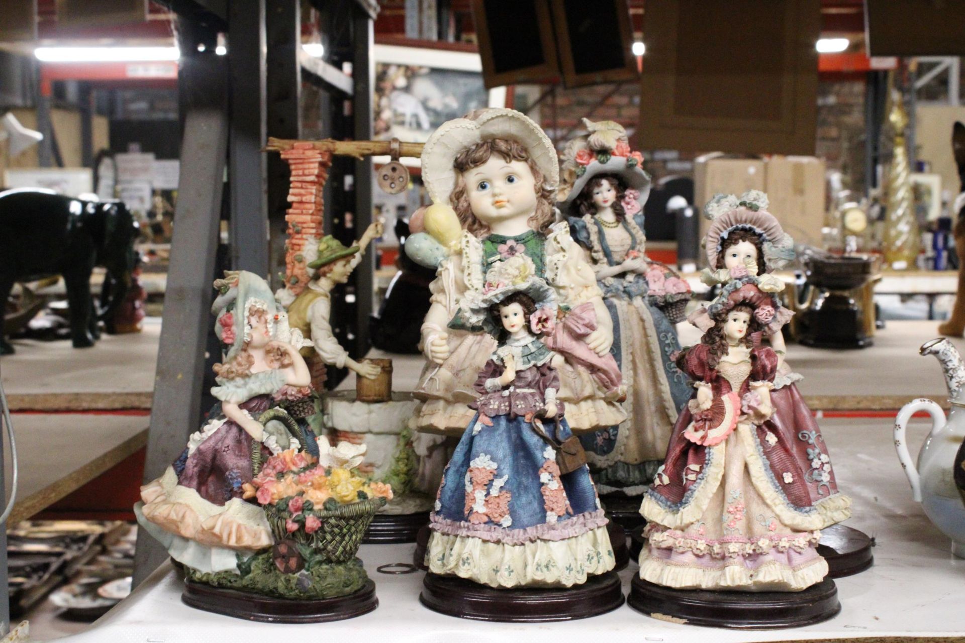 A COLLECTION OF EIGHT RESIN LADY FIGURINES