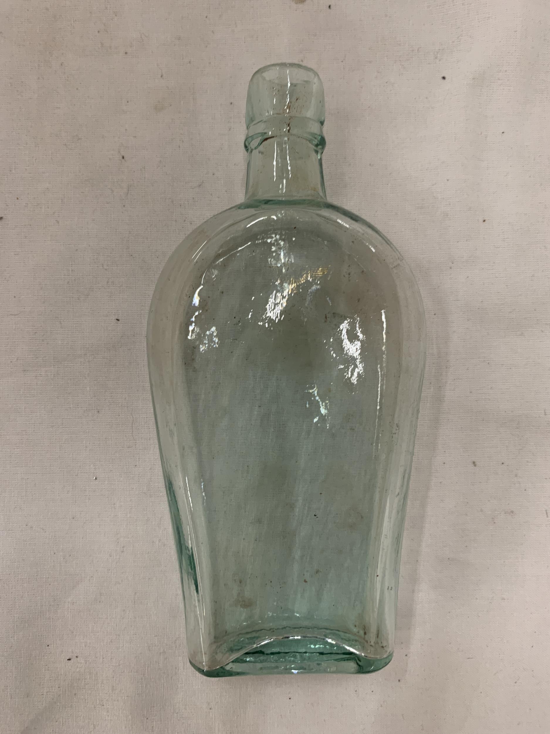 A VINTAGE GERMAN BOTTLE WITH A GOLD SWASTIKA