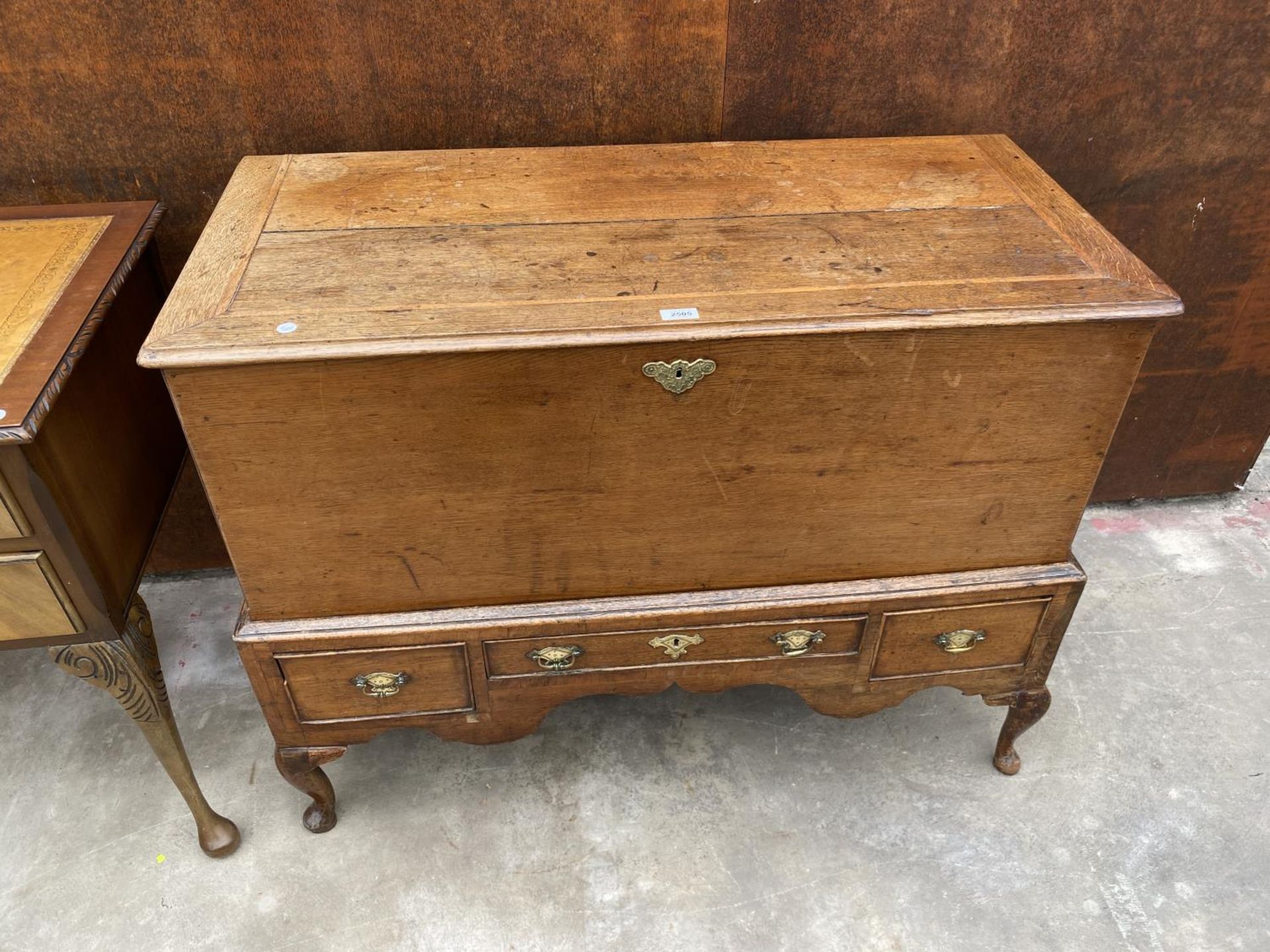 AN 18TH CENTURY OAK AND CROSSBANDED DOWRY CHEST ON STAND, ENCLOSING THREE DRAWERS ON LATER