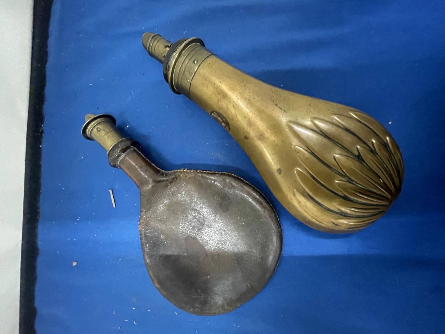 TWO VINTAGE POWDER FLASKS, ONE LEATHER AND ONE BRASS