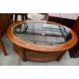 A MODERN OVAL COFFEE TABLE WITH INSET GLASS TOP AND SPLIT CANE UNDER TIER, 42" X 28"